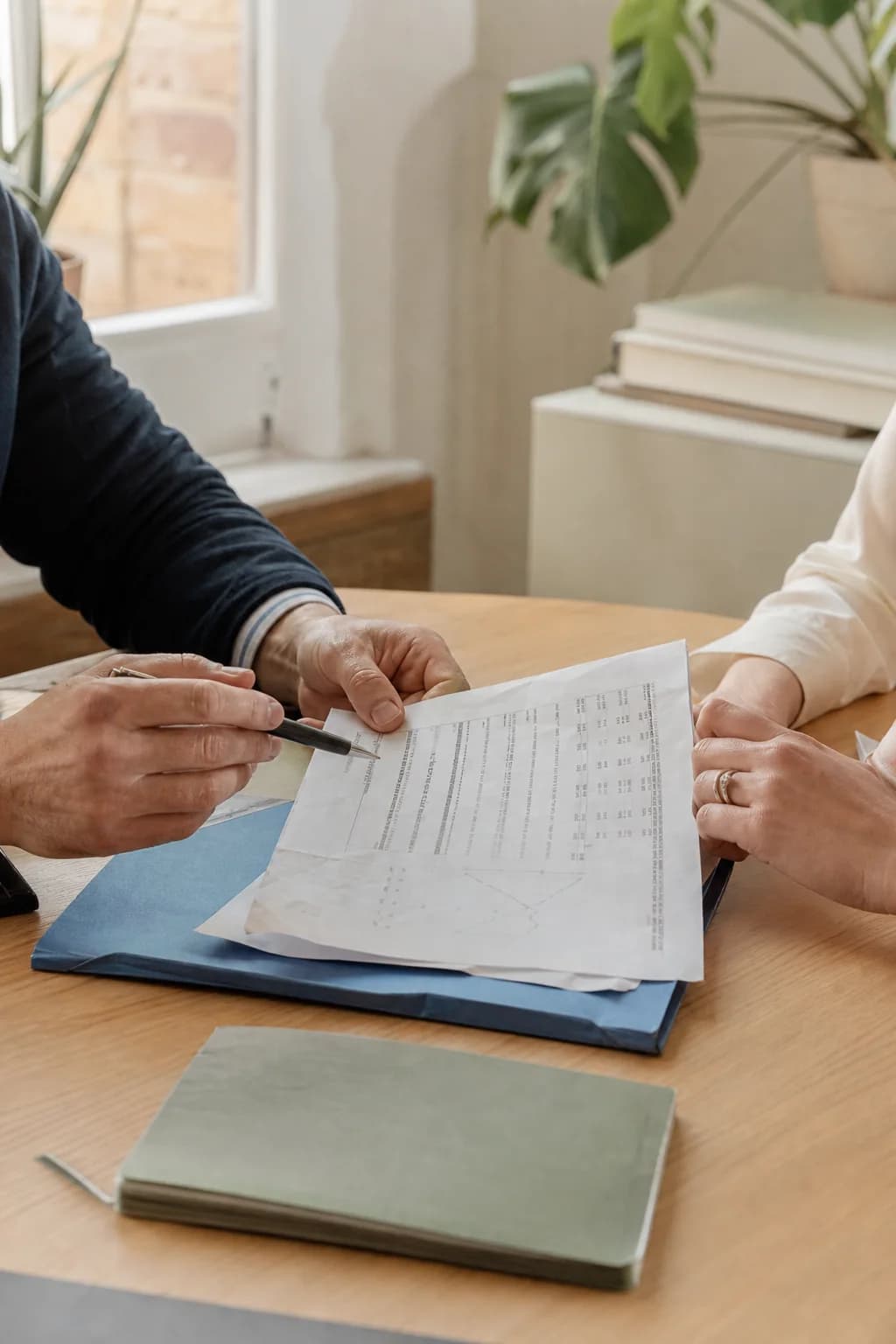 Illustrative scene of two people reviewing financial documents